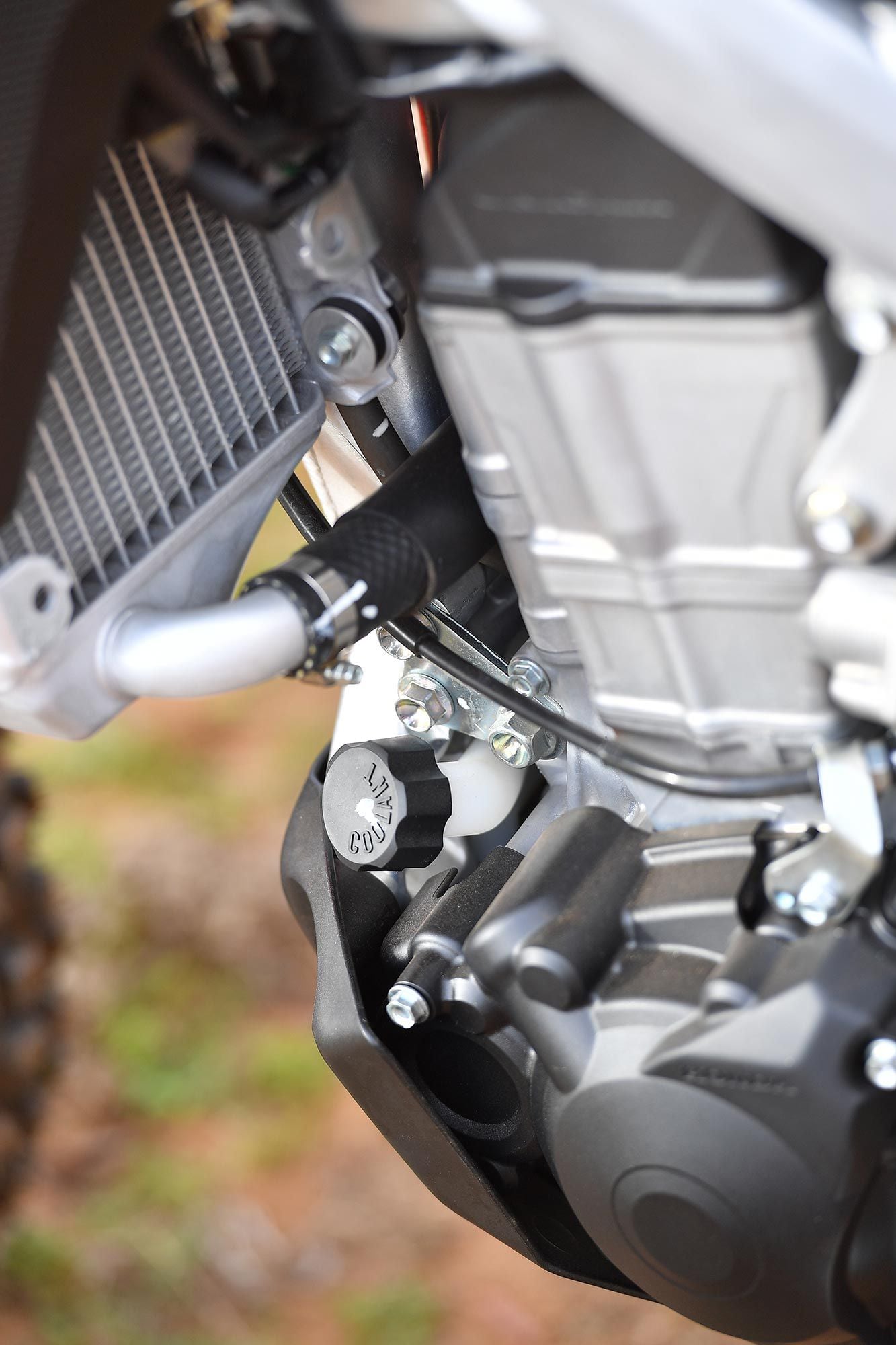 Radiator fluid overflow catch tank location is down low and well protected behind the full-coverage skid plate.