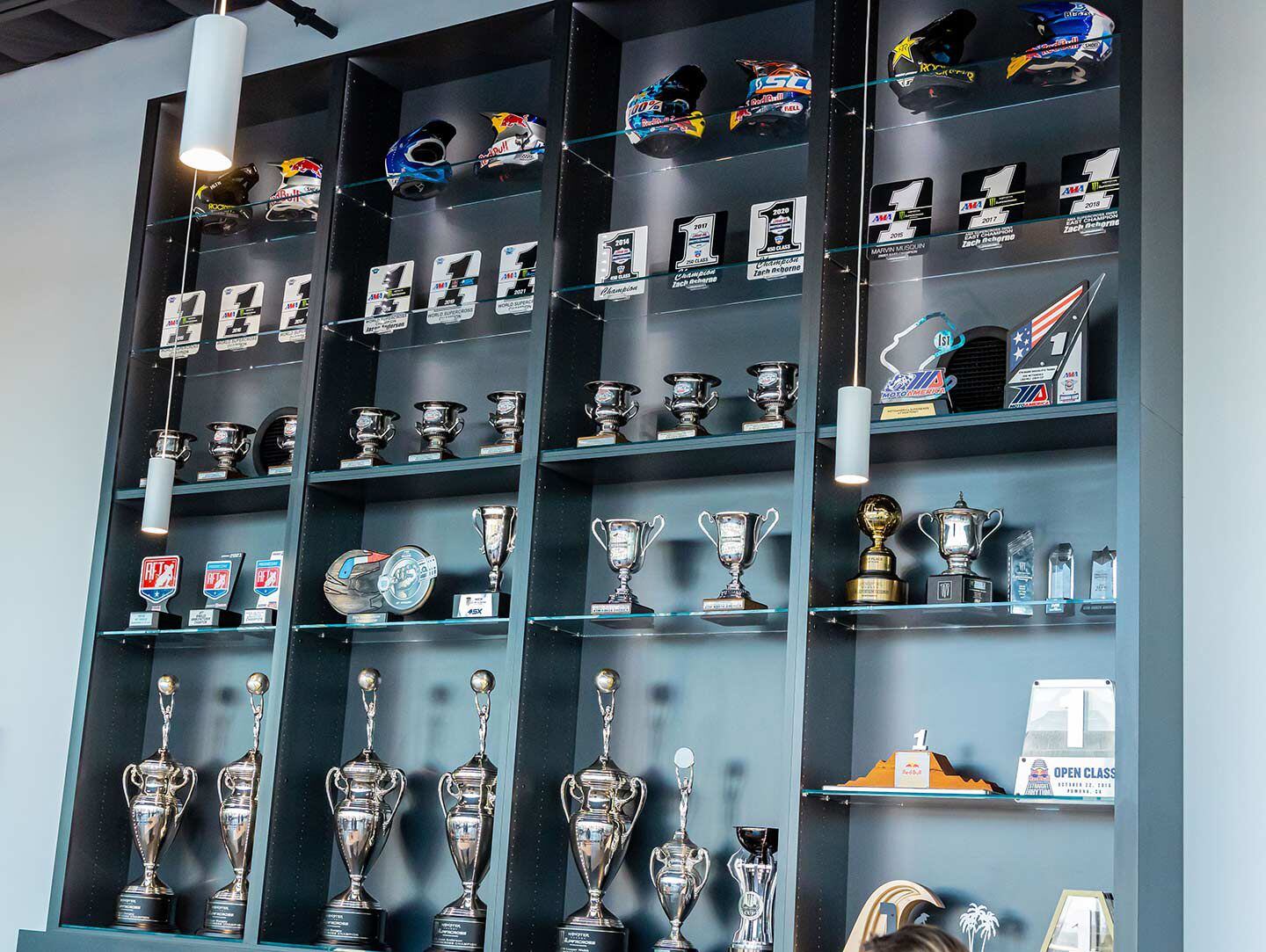 There’s no shortage of helmets, No. 1 plates, and trophies in the race team lobby.