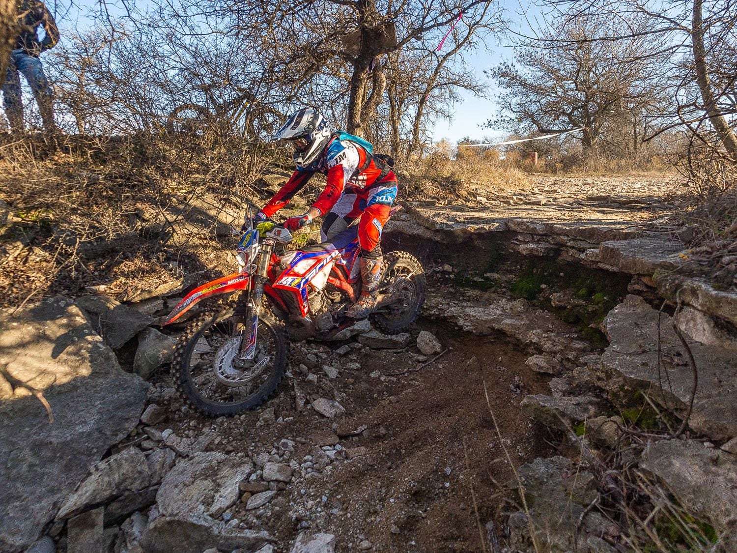 Upon landing, Gerston applies a minimal amount of front brake to soften the impact and prevent him from carrying too much momentum into the upcoming rocks.