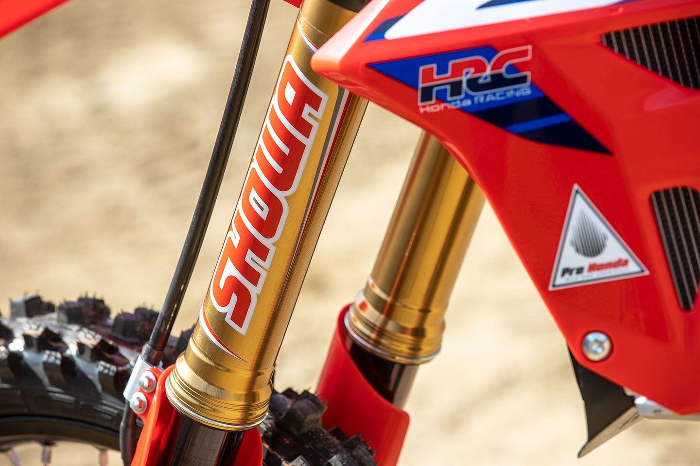 Kashima-coated uppers and titanium oxide-coated lower fork legs are CRF450RWE-specific. In the foreground, it’s interesting to note the Throttle Jockey–supplied graphics: Standard CRF450R shrouds with underlaid graphics are utilized while Throttle Jockey stickers are applied to complete the factory look.