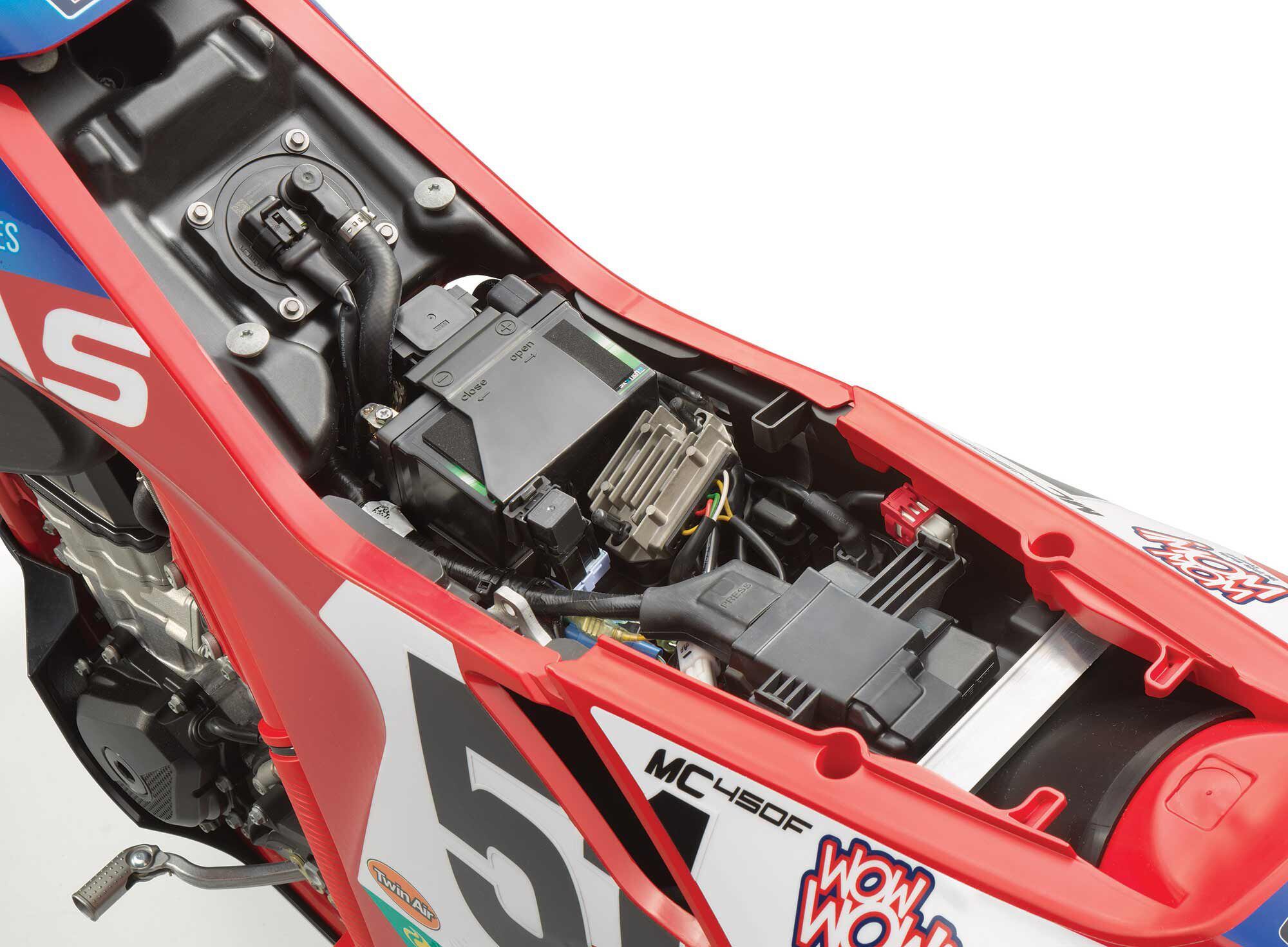 Here’s a view of what’s underneath the gripper seat. From left, you have the larger-than-usual 2.1-gallon tank with fuel pump, battery, then the harnesses and wiring for the extensive electronics package.