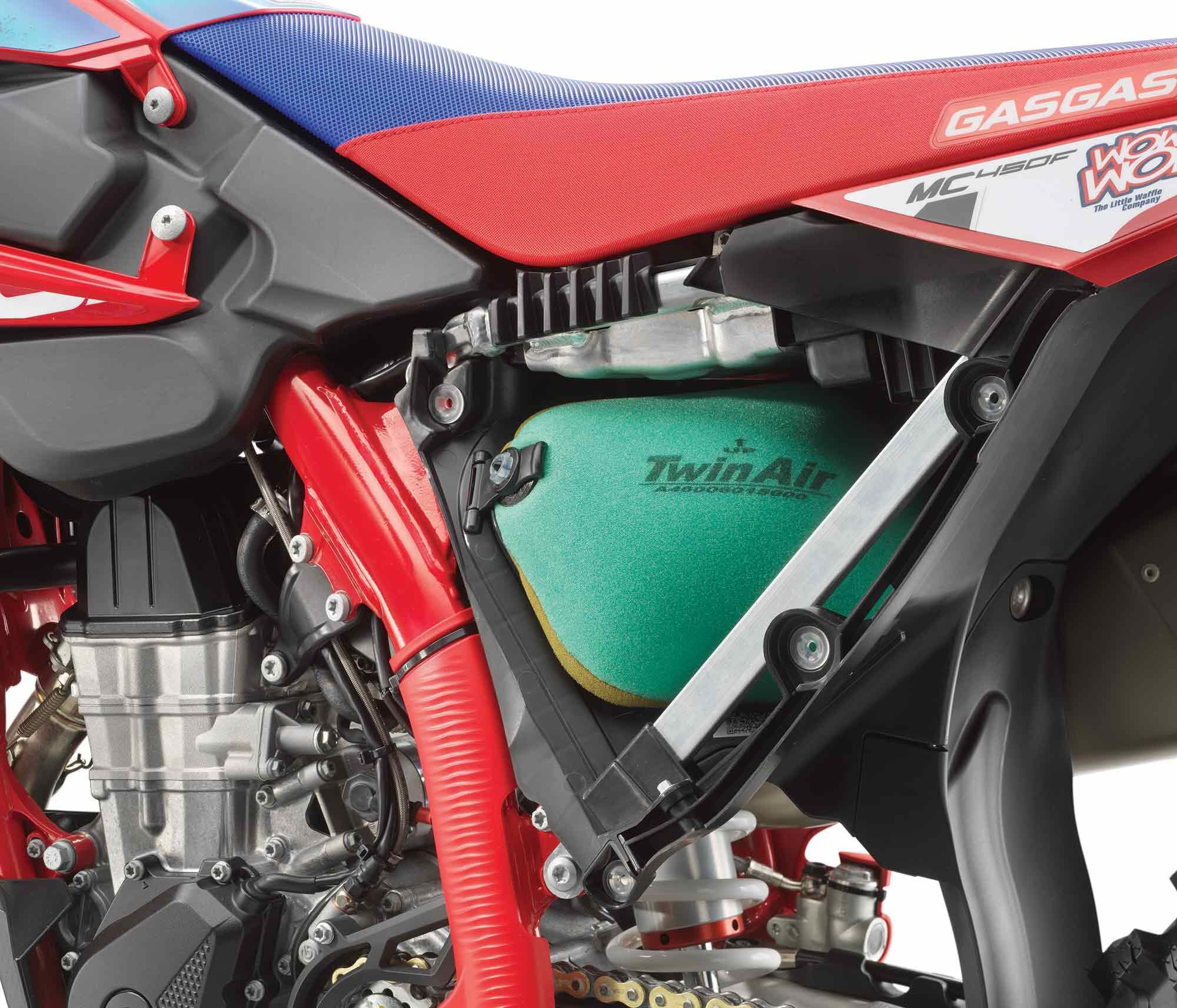 Pop off the left side panel on either bike to access the Twin Air filter. Visible here is just part of the frame that shows how different it is from the standard models, plus the aluminum subframe. The shallow aluminum structure above the filter houses the 12.8-volt/2-amp-hour lithium-ion battery that powers the array of electronics on both bikes.