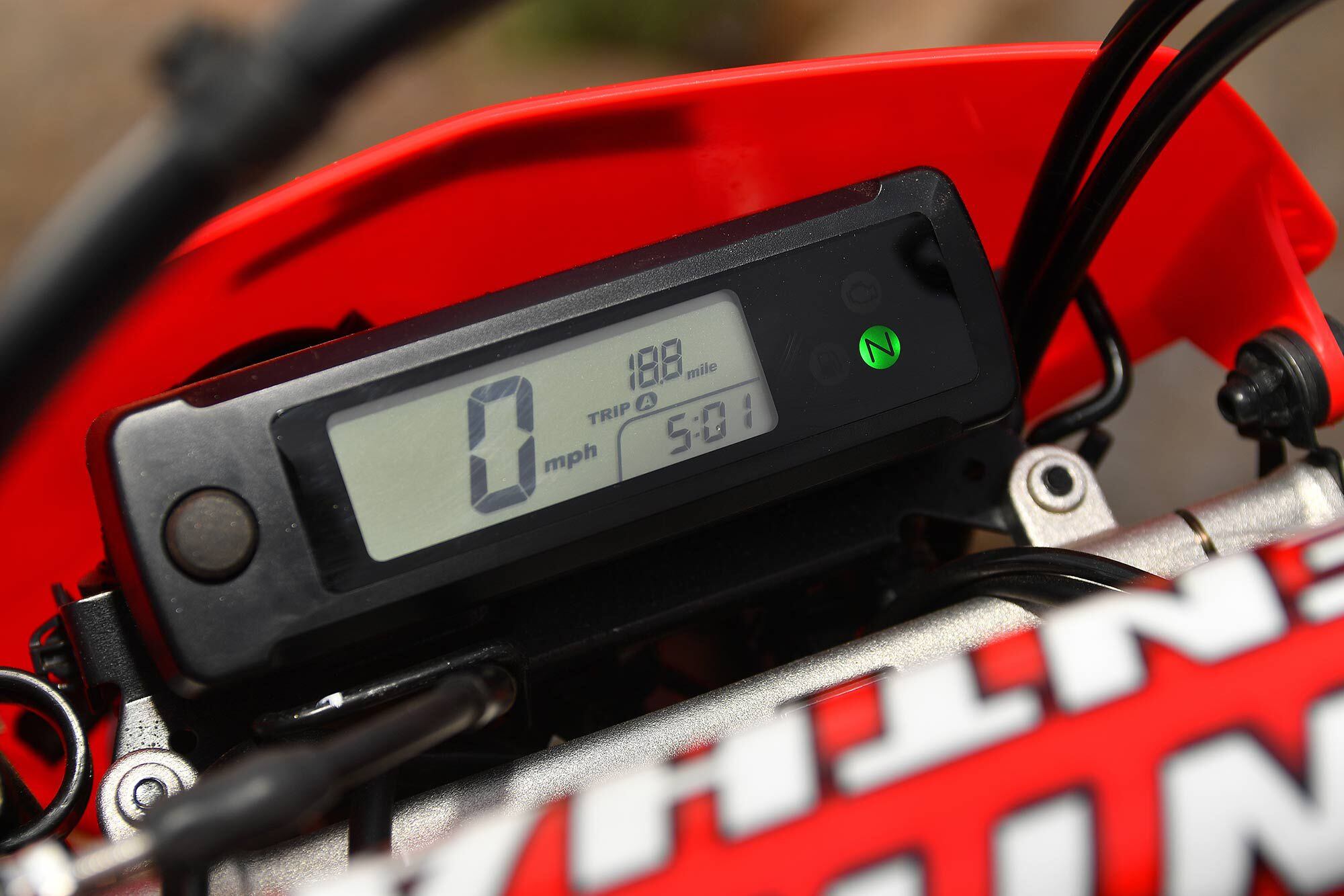 The compact digital meter is easy to read and the harness keeps the controls in their respective positions: upper front brake line guide on the left, throttle cables on the right, with the clutch cable and starting wires right down the middle.