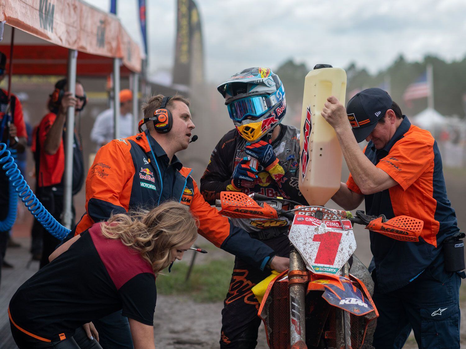 Crew chief Tony Hall talks to Russell during a gas stop while Mitcheff refuels the bike. Russell’s wife, Chandler, is there to provide new goggles.