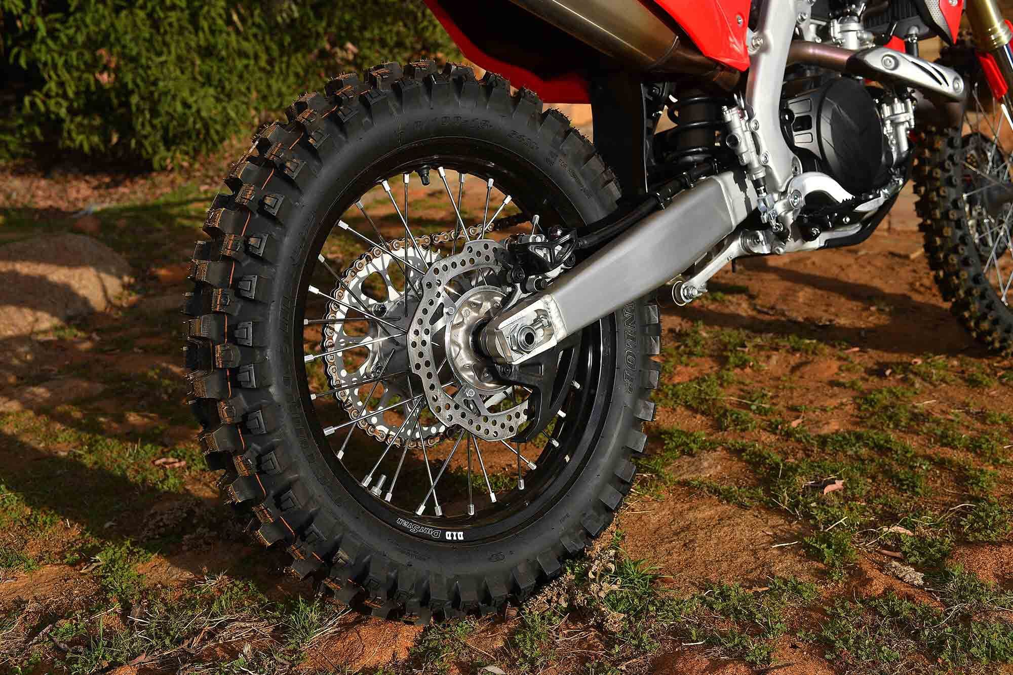 Pictured is the Dunlop Geomax MX52 tire (110/100-18), 240mm rear rotor with disc protection, single side exhaust, D.I.D DirtStar rim, and rearward axle placement that gives the bike even more stability.